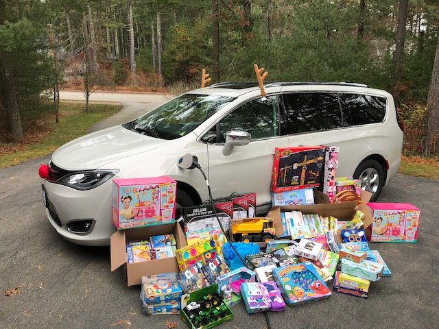 Toys to donate displayed beside a car